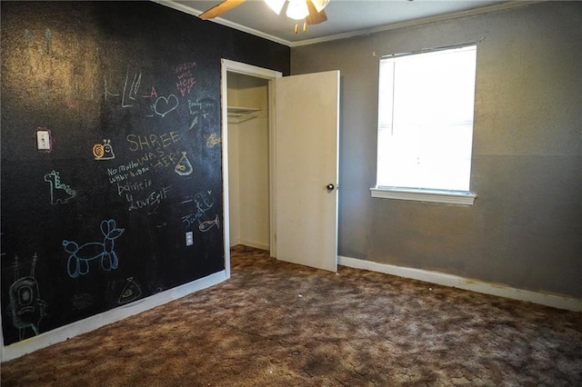 unfurnished bedroom featuring carpet floors, ornamental molding, and baseboards