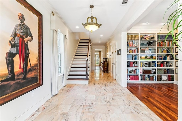 hallway featuring recessed lighting, crown molding, baseboards, and stairs