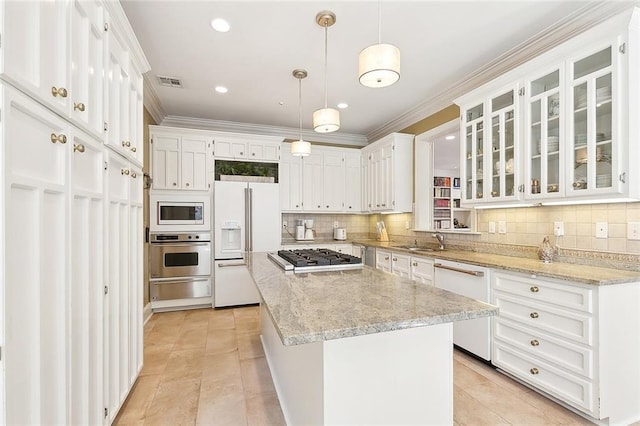 kitchen featuring stainless steel appliances, white cabinetry, a warming drawer, and visible vents