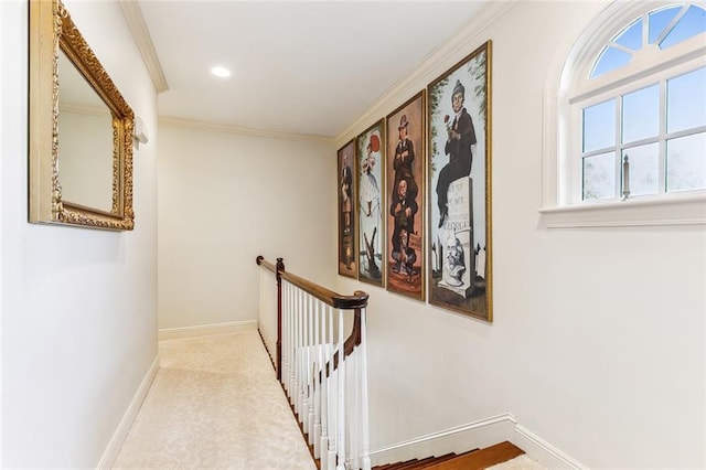 hallway with baseboards, ornamental molding, an upstairs landing, and recessed lighting