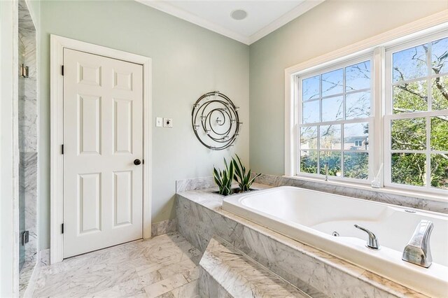 bathroom with marble finish floor, crown molding, and a bath