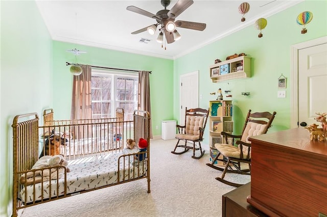 bedroom featuring carpet flooring, a ceiling fan, visible vents, baseboards, and ornamental molding