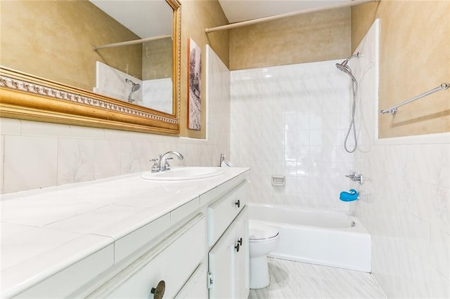 bathroom featuring shower / bath combination, vanity, tile walls, and toilet