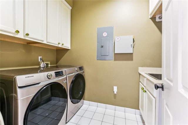 washroom featuring electric panel, cabinet space, light tile patterned flooring, washer and dryer, and baseboards