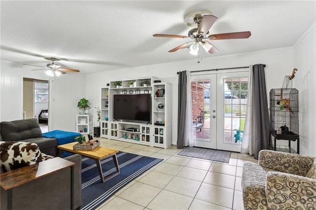 tiled living area with ceiling fan and french doors