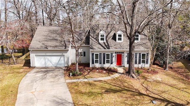 cape cod house with concrete driveway, roof with shingles, an attached garage, fence, and a front lawn