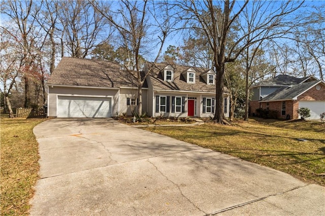 cape cod house featuring an attached garage, driveway, fence, and a front yard