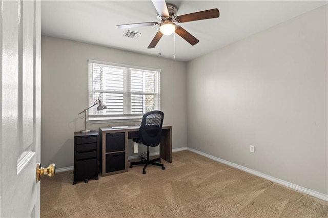 office featuring light carpet, baseboards, visible vents, and ceiling fan