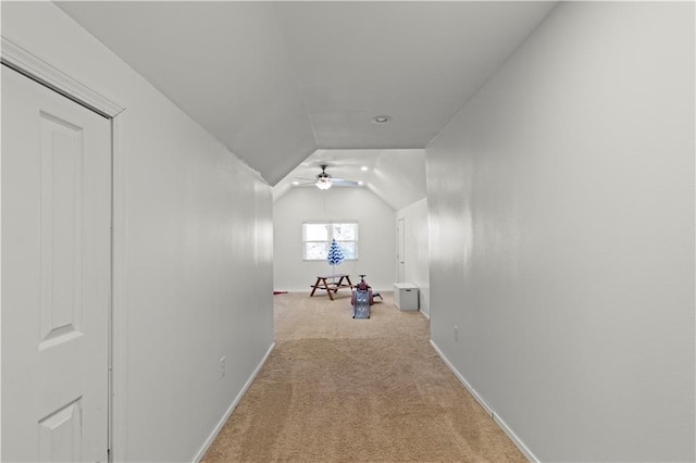 bonus room with lofted ceiling, baseboards, a ceiling fan, and light colored carpet