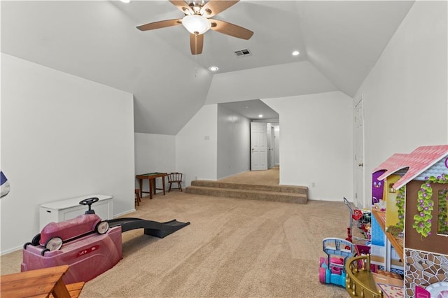 playroom with visible vents, vaulted ceiling, carpet flooring, and ceiling fan