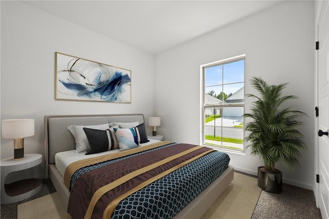 carpeted bedroom featuring baseboards