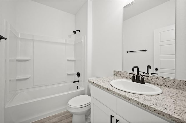 bathroom with vanity, shower / tub combination, wood finished floors, and toilet