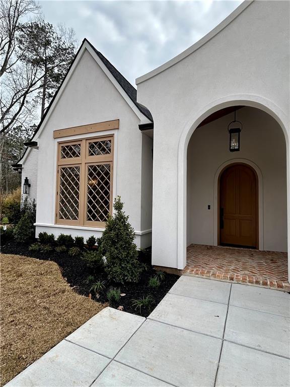 doorway to property with stucco siding