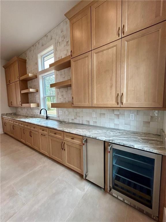 kitchen featuring decorative backsplash, wine cooler, light stone counters, light brown cabinets, and open shelves