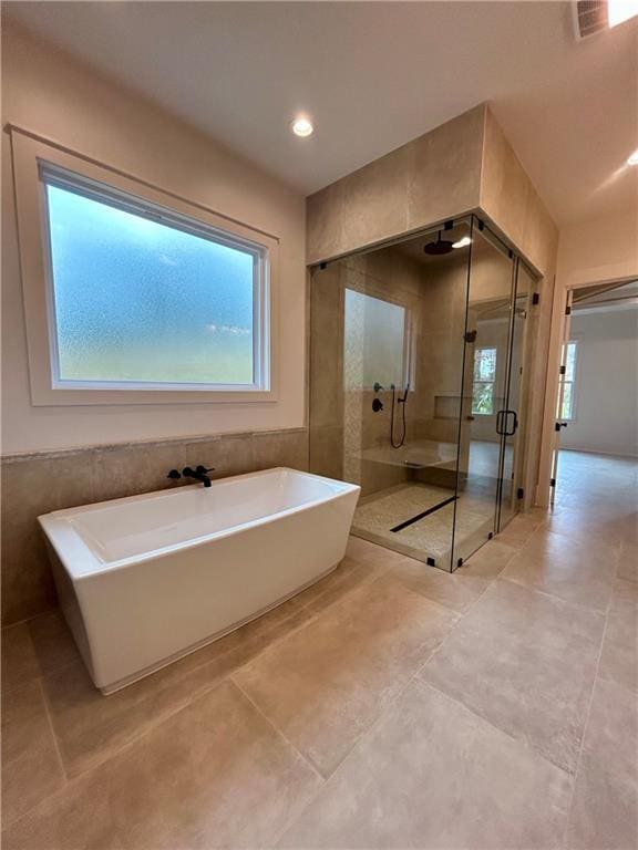 full bathroom featuring a stall shower, visible vents, a freestanding bath, and recessed lighting