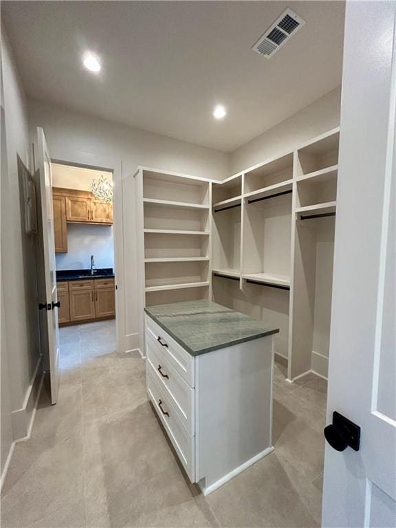 spacious closet featuring a sink and visible vents