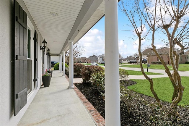 view of patio / terrace with a residential view and a porch