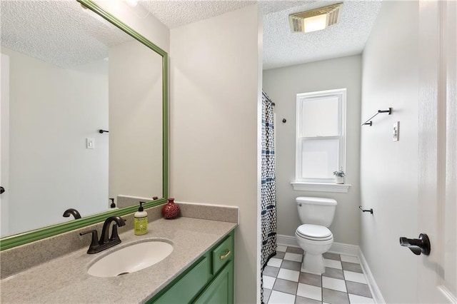 bathroom featuring visible vents, toilet, a textured ceiling, vanity, and baseboards