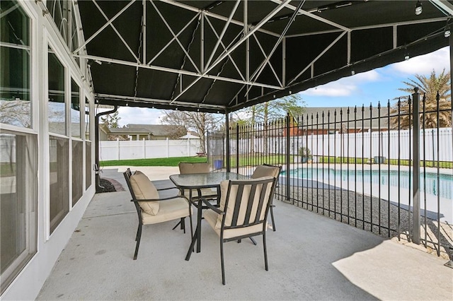 view of patio / terrace featuring a fenced in pool, outdoor dining area, and a fenced backyard