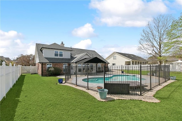 view of swimming pool featuring a fenced in pool, a fenced backyard, a yard, and a patio