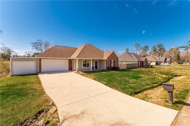 ranch-style house with driveway, a garage, fence, a front yard, and brick siding