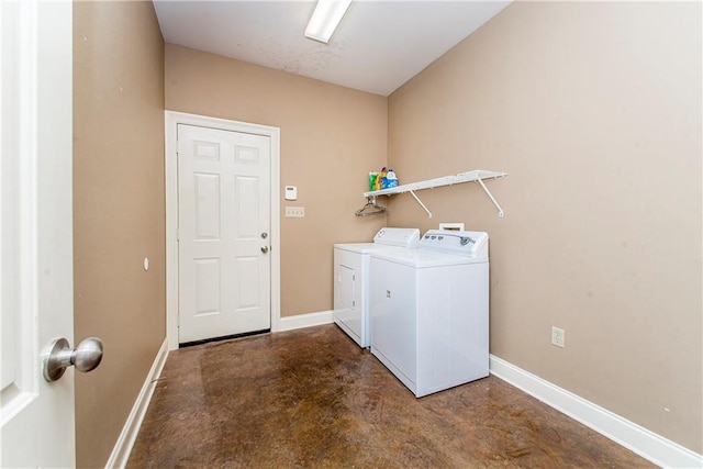 laundry area featuring laundry area, washing machine and clothes dryer, and baseboards