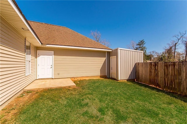 view of yard with an outbuilding, a storage shed, and a fenced backyard