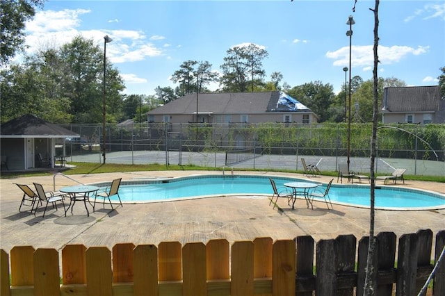 14249 Woodlands Dr Unit 22, Hammond, LA 70401 - view of pool with a tennis court, fence, a fenced in pool, and a patio