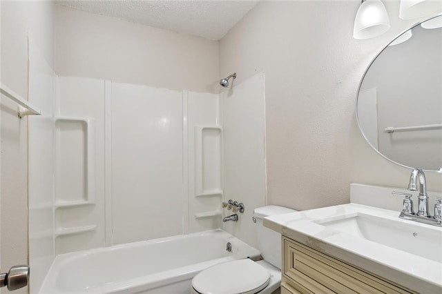 bathroom with a textured ceiling, vanity, bathtub / shower combination, and toilet