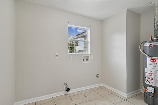 washroom featuring laundry area, light tile patterned floors, hookup for a gas dryer, washer hookup, and gas water heater