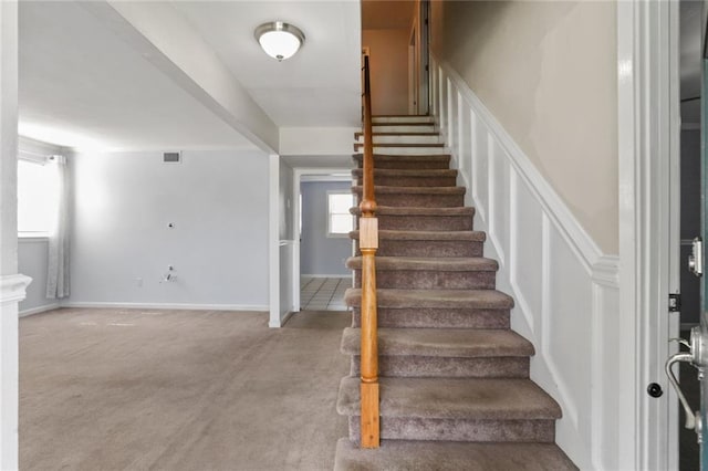 staircase with carpet and visible vents