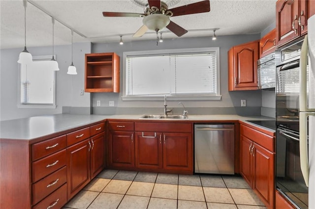 kitchen featuring a textured ceiling, light tile patterned floors, a peninsula, a sink, and black appliances