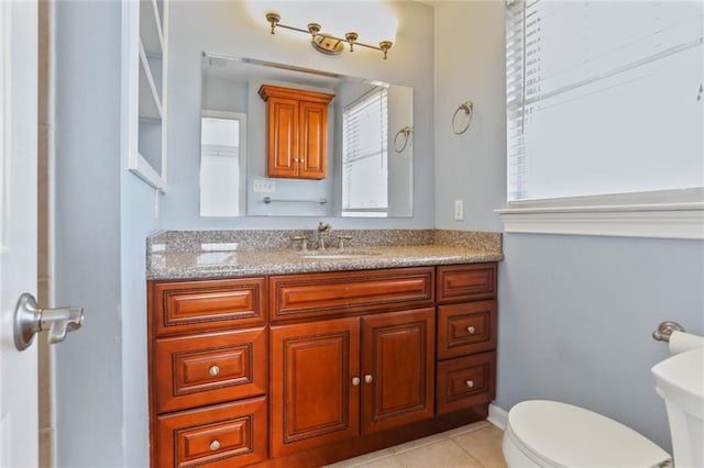 bathroom with vanity, tile patterned flooring, and toilet