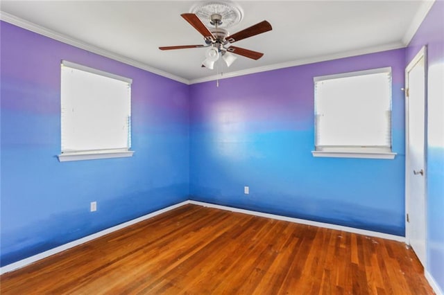 unfurnished room featuring baseboards, wood finished floors, a ceiling fan, and crown molding