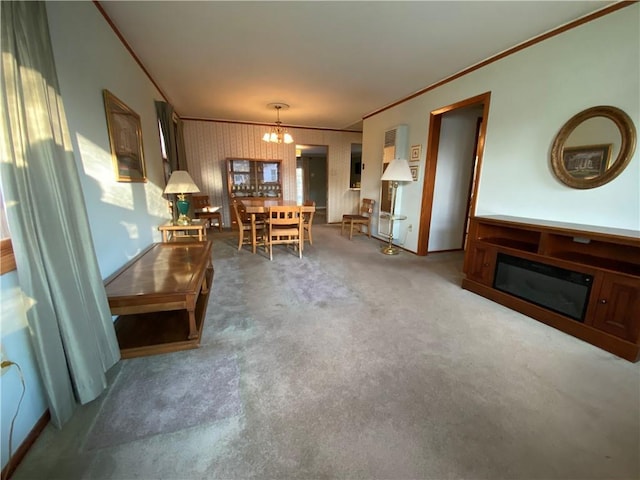 unfurnished dining area with carpet, a fireplace, a chandelier, and crown molding