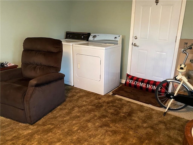 clothes washing area with laundry area, carpet, and separate washer and dryer