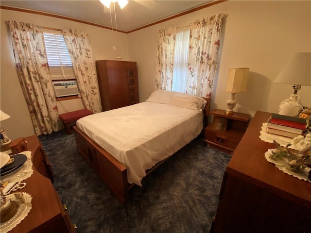 bedroom with ornamental molding, dark carpet, and a ceiling fan