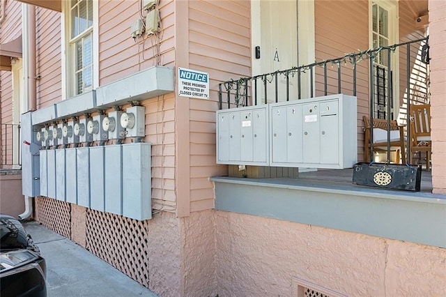 exterior space featuring electric meter and mail area