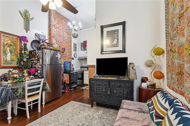 living room with dark wood-style flooring and ceiling fan with notable chandelier