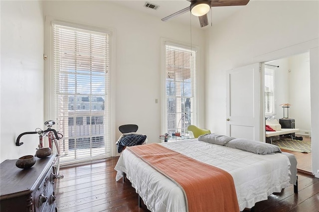 bedroom featuring dark wood-style floors, access to outside, visible vents, and a ceiling fan