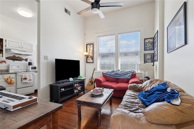 living area featuring ceiling fan, dark wood finished floors, and visible vents