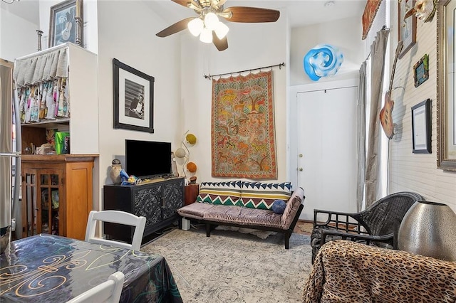 sitting room featuring a ceiling fan