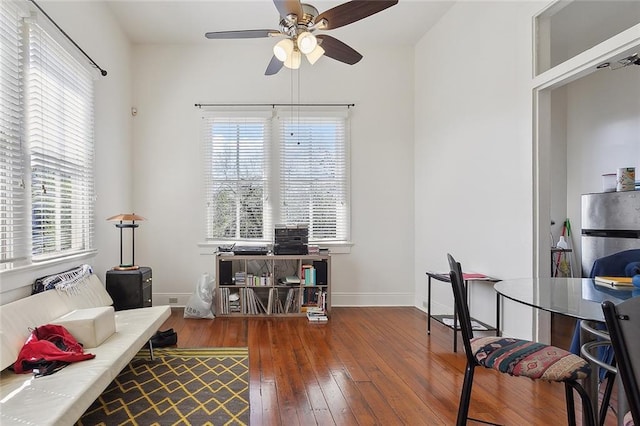 office space with ceiling fan, hardwood / wood-style floors, and baseboards