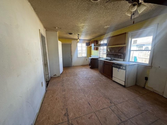 kitchen featuring a textured ceiling and white dishwasher