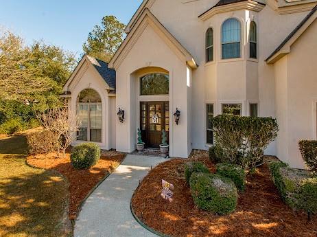 entrance to property featuring stucco siding