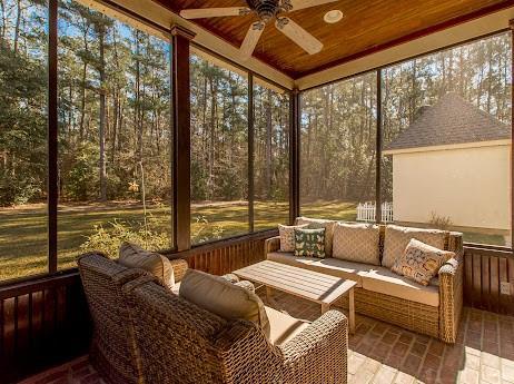 sunroom / solarium with a wealth of natural light, wood ceiling, and a ceiling fan