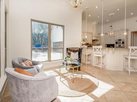 living room with light tile patterned flooring, a wealth of natural light, and recessed lighting