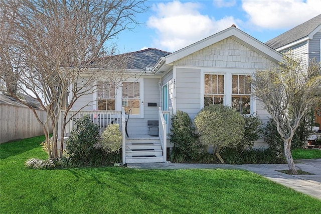 bungalow-style home with driveway and a front lawn