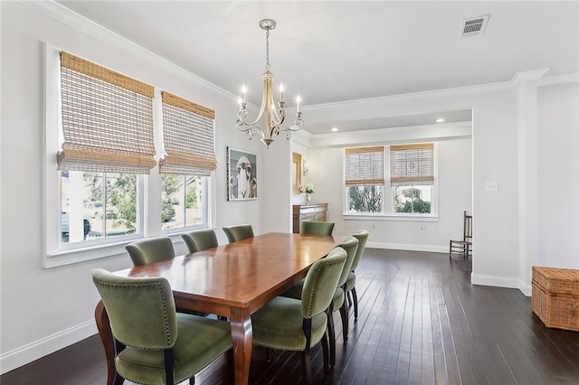 dining area featuring a healthy amount of sunlight, dark wood-style flooring, visible vents, and crown molding