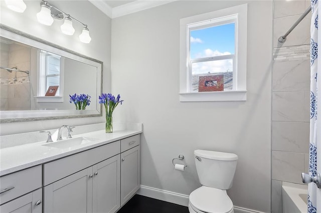 full bathroom featuring crown molding, toilet, vanity, and baseboards